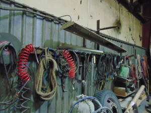 LOT CONSISTING OF: assorted cables, hose, rope & tools (located along wall)